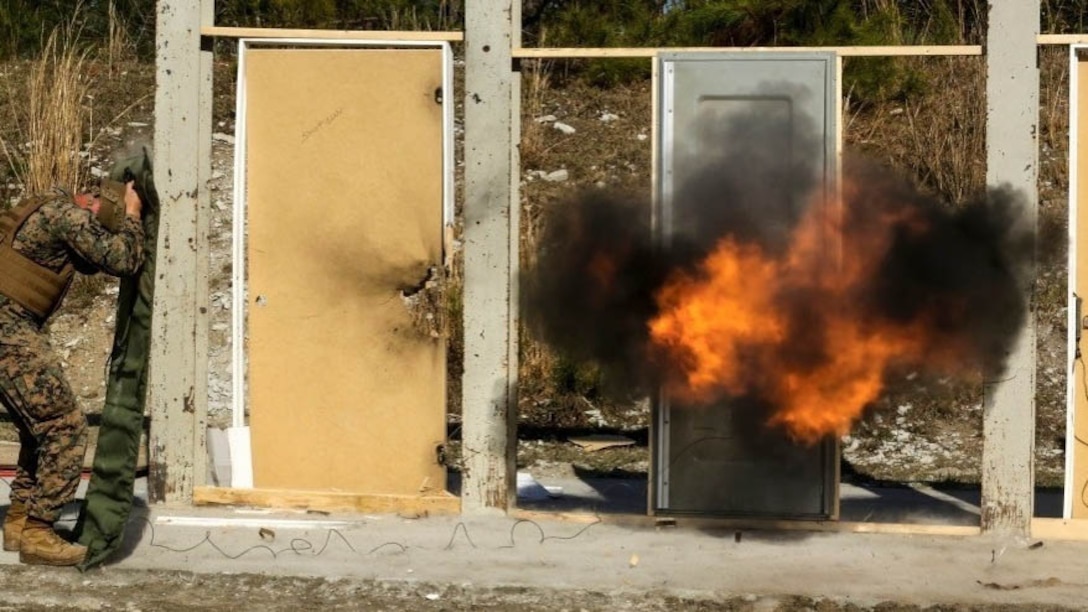 Marines detonate an explosive charge on a door during a breaching exercise at Marine Corps Base Camp Lejeune, N.C., March 30, 2017. The Marines and Sailors practiced techniques on how to successfully get through locked doors using shotguns and explosive charges. The Marines and sailors are with 2nd Reconnaissance Battalion. 