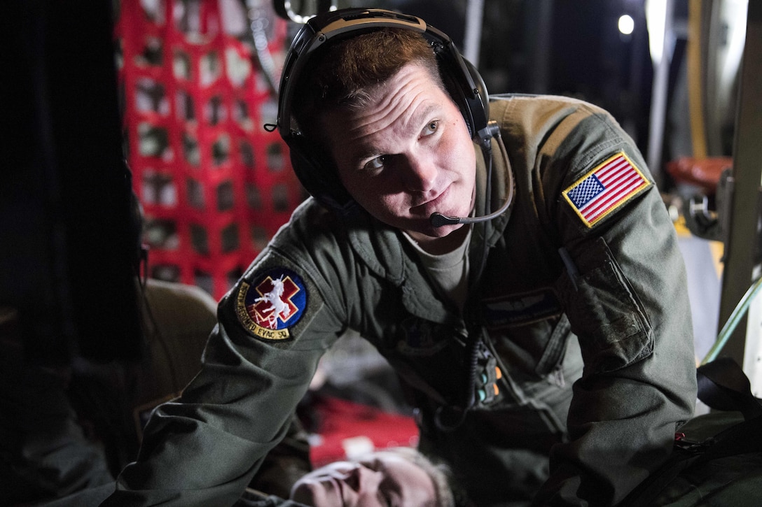 West Virginia Air National Guard Staff Sgt. Daniel Bowen provides care for a mock psychiatric patient aboard an Air Force C-130 Hercules aircraft at McLaughlin Air National Guard Base, Charleston, W.Va., April 2, 2017. Bowen is an aeromedical evacuation technician assigned to the West Virginia Air National Guard’s 167th Aeromedical Evacuation Squadron. Air National Guard photo by Capt. Holli Nelson 
