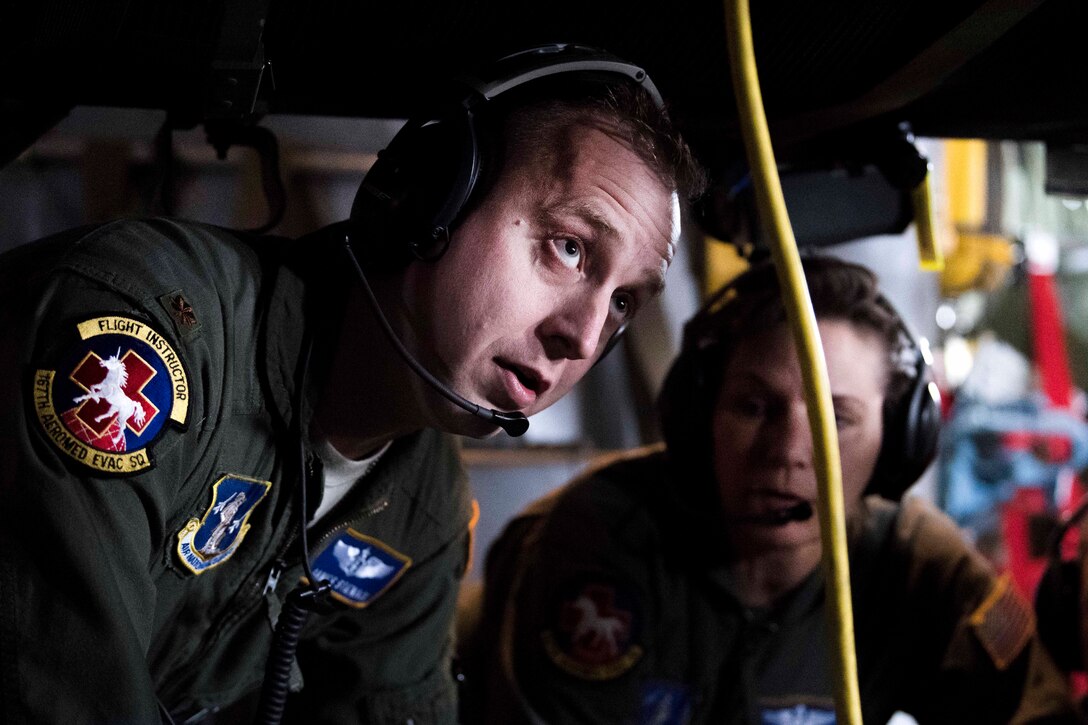 West Virginia Air National Guard Maj. James Stenack, left, provides care for a mock patient aboard an Air Force C-130 Hercules aircraft at McLaughlin Air National Guard Base, Charleston, W.Va., April 2, 2017. Stenack is a flight nurse assigned to the West Virginia Air National Guard’s 167th Aeromedical Evacuation Squadron. Air National Guard photo by Capt. Holli Nelson