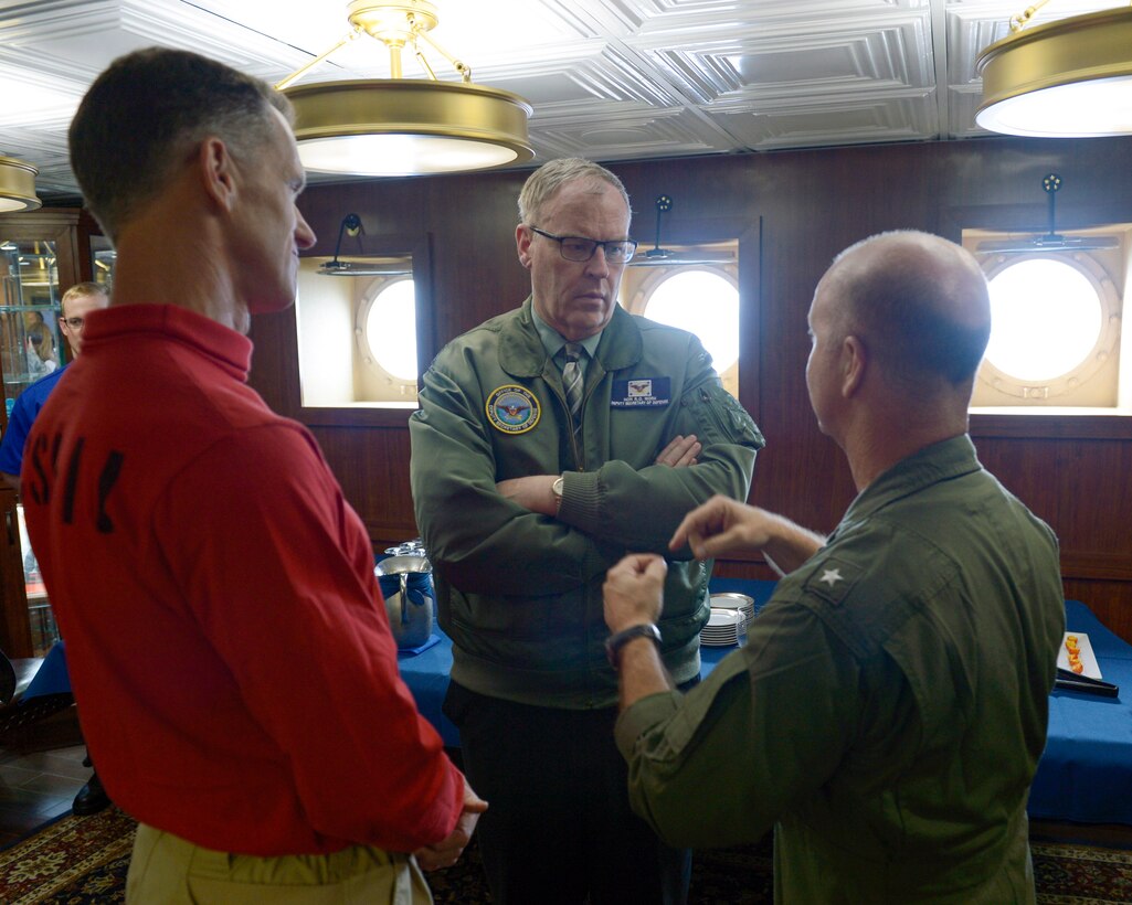 Deputy Defense Secretary Bob Work, center, speaks with Navy Rear Adm. William Byrne, left, commander of Carrier Strike Group 11, and Navy Rear Adm. Ross Myers, commander of Carrier Strike Group 15, during a visit to the aircraft carrier USS Nimitz at sea in the Pacific Ocean, April 4, 2017. Nimitz is underway conducting a composite training unit exercise with the Nimitz Carrier Strike Group in preparation for an upcoming deployment. Navy photo by Seaman Leon Wong