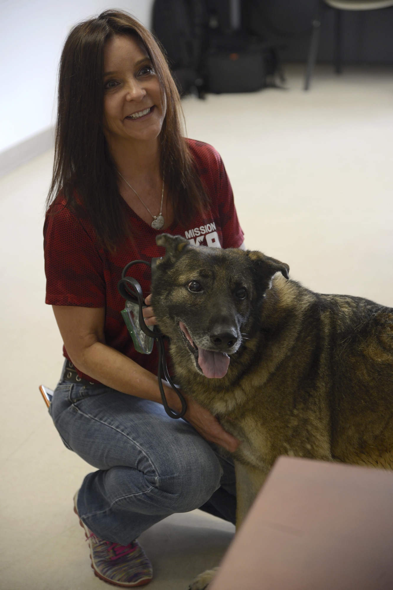 Kristen Maurer, president of Mission K9 Rescue, pauses for a photo with military working dog Zoran at MacDill Air Force Base, Fla., March 31, 2017. Maurer took Zoran to Mission K9 Rescue to live out his retirement after seven years of service to the U.S. Air Force. (U.S. Air Force photo by Senior Airman Tori Schultz)