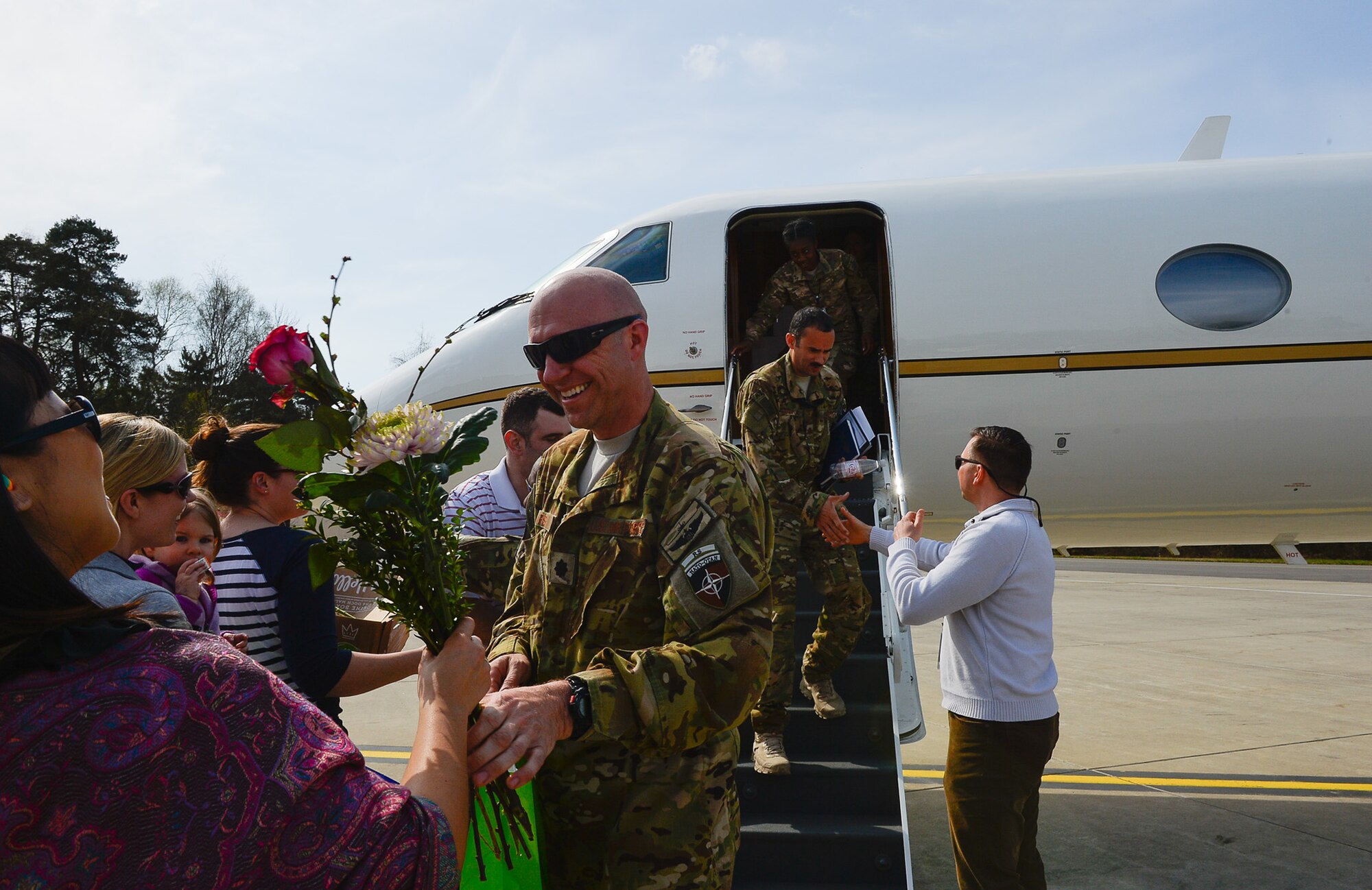 Maj. Jeffrey Aubry, 76th Airlift Squadron pilot, is welcomed home from a six month deployment with flowers on Ramstein Air Base, Germany, April 1, 2017. While deployed, the 76th AS served as the official transportation for the commander of Resolute Support Mission (COMRES), U.S. Army Gen. John W. Nicholson, Jr. Resolute Support Mission is a NATO-led train, advise, and assist mission for the Afghan security forces, consisting of more than 13,000 military service members. (U.S. Air Force photo by Airman 1st Class Joshua Magbauna)