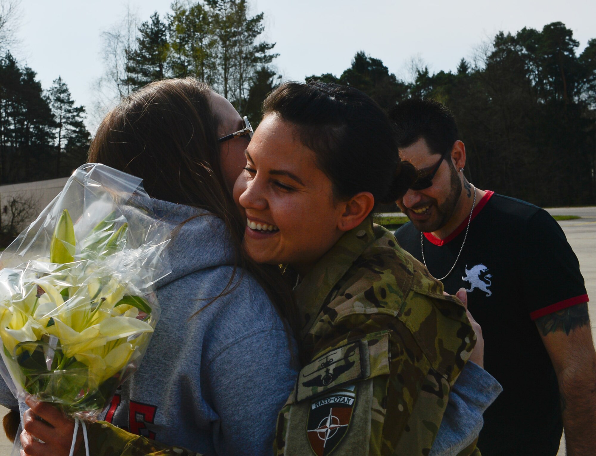 Staff Sgt. Ashleen Martinez, 76th Airlift Squadron evaluator flight attendant, hugs a friend after returning from a deployment on Ramstein Air Base, Germany, April 1, 2017. The 76th AS and other services that support the commander of the Resolute Support Mission provide time-critical airlift support to the mission in Afghanistan by facilitating intra-theater and inter-theater airlift for the commander as he continues to further the Afghan security transition. (U.S. Air Force photo by Airman 1st Class Joshua Magbauna)