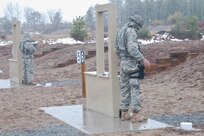 Soldiers stand ready to engage targetsat the M9 pistol marksmanship event of the Best Warrior Competition at Fort Devens on April 4, 2017.