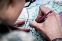 Specialist Natalie Harper, a competitor in the 80th Training Command and 99th Regional Support Command’s combined Best Warrior Competition, plots points during the land navigation portion of the competition, here, April, 5, 2017.