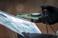 U.S. Army Sergeant Nicole Paese, a public affairs specialist with the 361st Press Camp Headquarters, checks her compass during the daytime land navigation portion of the 80th Training Command and 99th Regional Support Command’s combined Best Warrior Competition April 5, 2017.