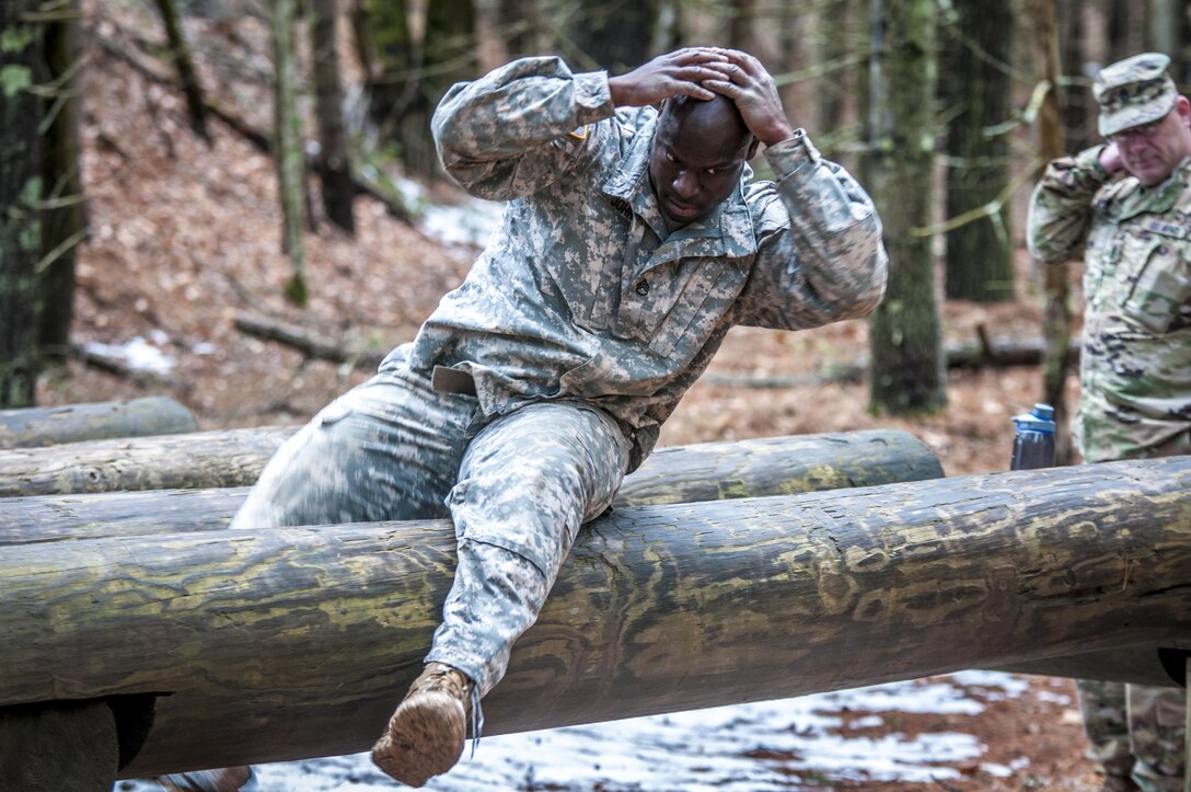 U.S. Army Staff Sgt. Harry John II climbs over an obstacle during the 80th Training Command and 99th Regional Support Command’s combined Best Warrior Competition April 5, 2017.