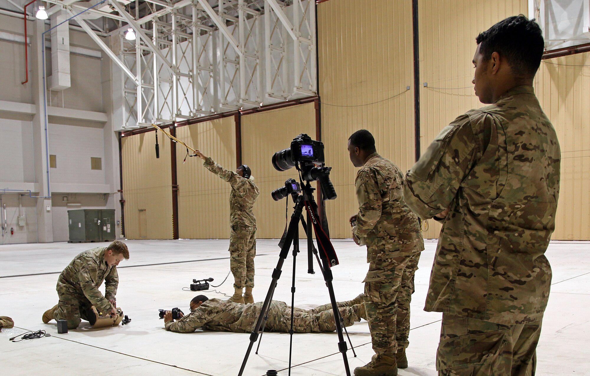 U.S. Army Soldiers assigned to the Military Information Support Task Force-Central (MISTF-C) Production Development Detachment capture a Psychological Operations Specialist setting up a Next Generation Loudspeaker System on Dec. 7, 2016 at Al Udeid Air Base, Qatar. (US Army Photo by Staff Sgt. Brian)