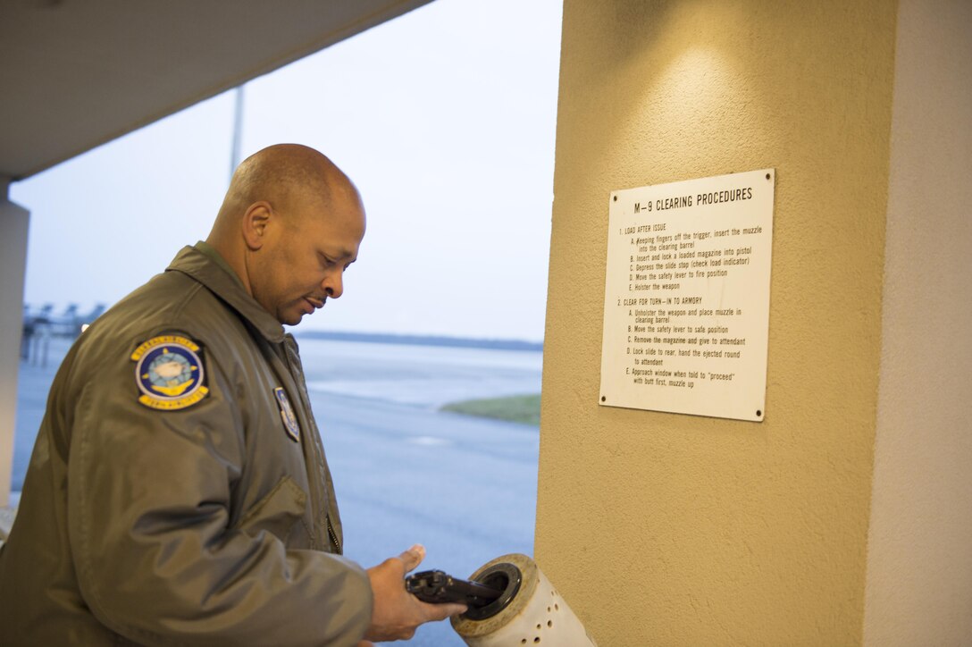 Senior Master Sgt. Bernard London, 709th Airlift Squadron, clears his weapon before boarding a C-5M Super Galaxy flying to Joint Base Langley-Eustis, Va. to support a joint emergency deployment exercise, Dover Air Force Base, Del., March 18, 2017.  The joint-exercise demonstrated loading and unloading procedures of personnel and equipment. (U.S. Air Force photo/ Tech. Sgt. Mercedes Crossland)
