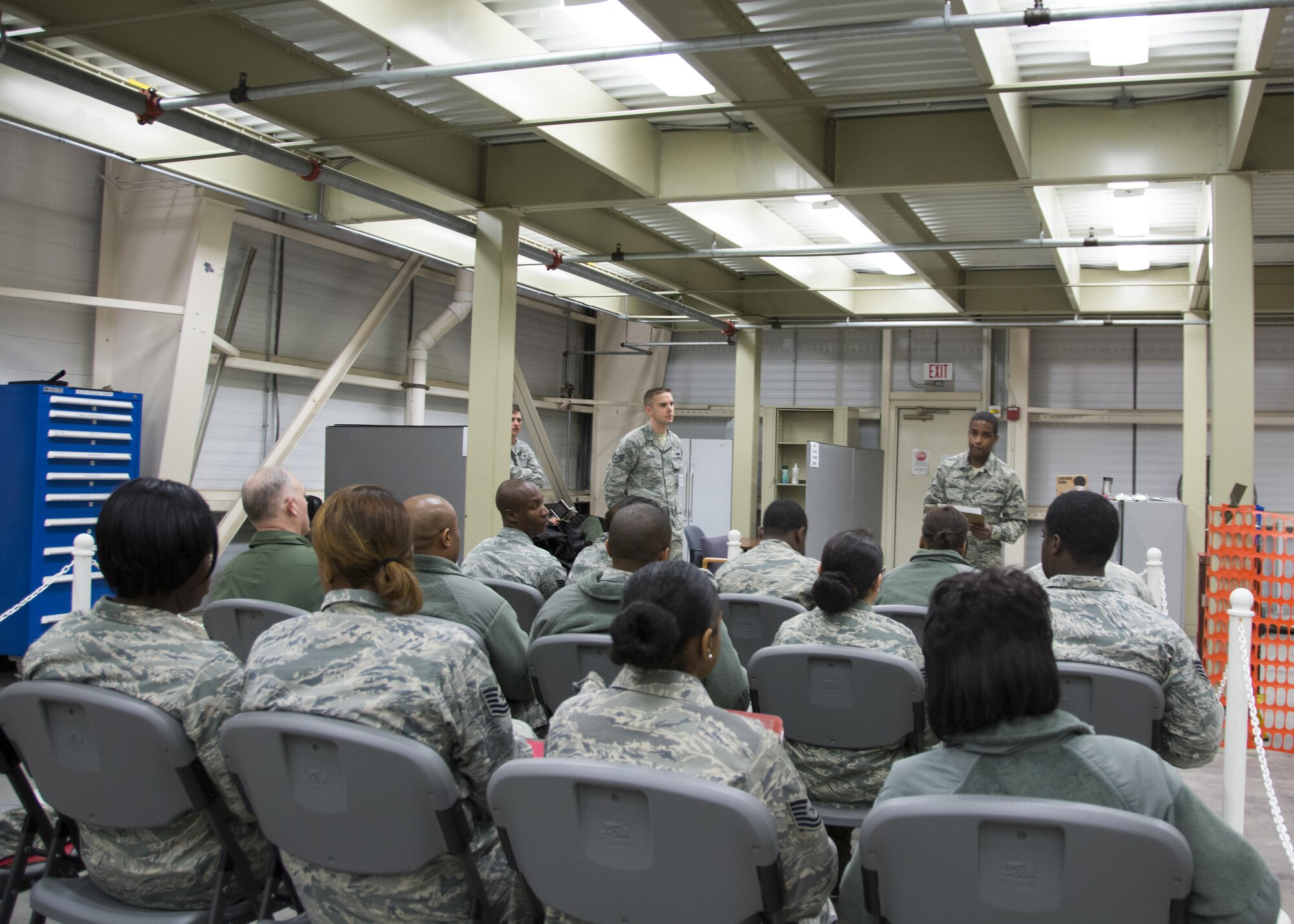 Staff Sgt. Michael Mann, 512th Force Support Squadron, delivers a safety brief to 512th Airlift Wing members during a pre-deployment function line exercise, Dover Air Force Base, Del., April 2, 2017. Mann briefed emergency evacuation procedures for the facility during the exercise. (U.S Air Force photo/Senior Airman Damien Taylor)
