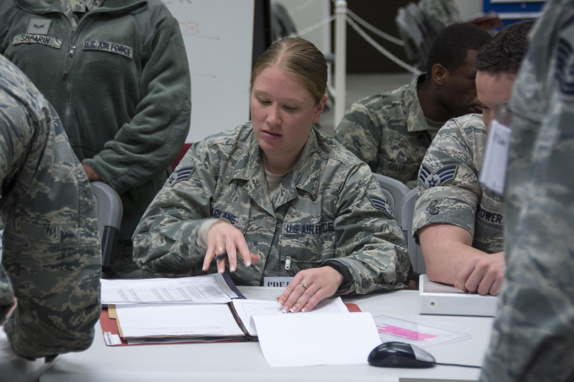 Senior Airman. Samantha McFarlane, 512th Force Support Squadron, inspects and prepares mobility folders of 512th Airlift Wing members during deployment function line exercise, Dover Air Force Base, Del. Apr. 2, 2017. Mobility folders were examined and corrected of all discrepancies to display FSS core task competency and ensure deployment readiness for members. (U.S. Air Force Photo/Senior Airman. Damien Taylor)