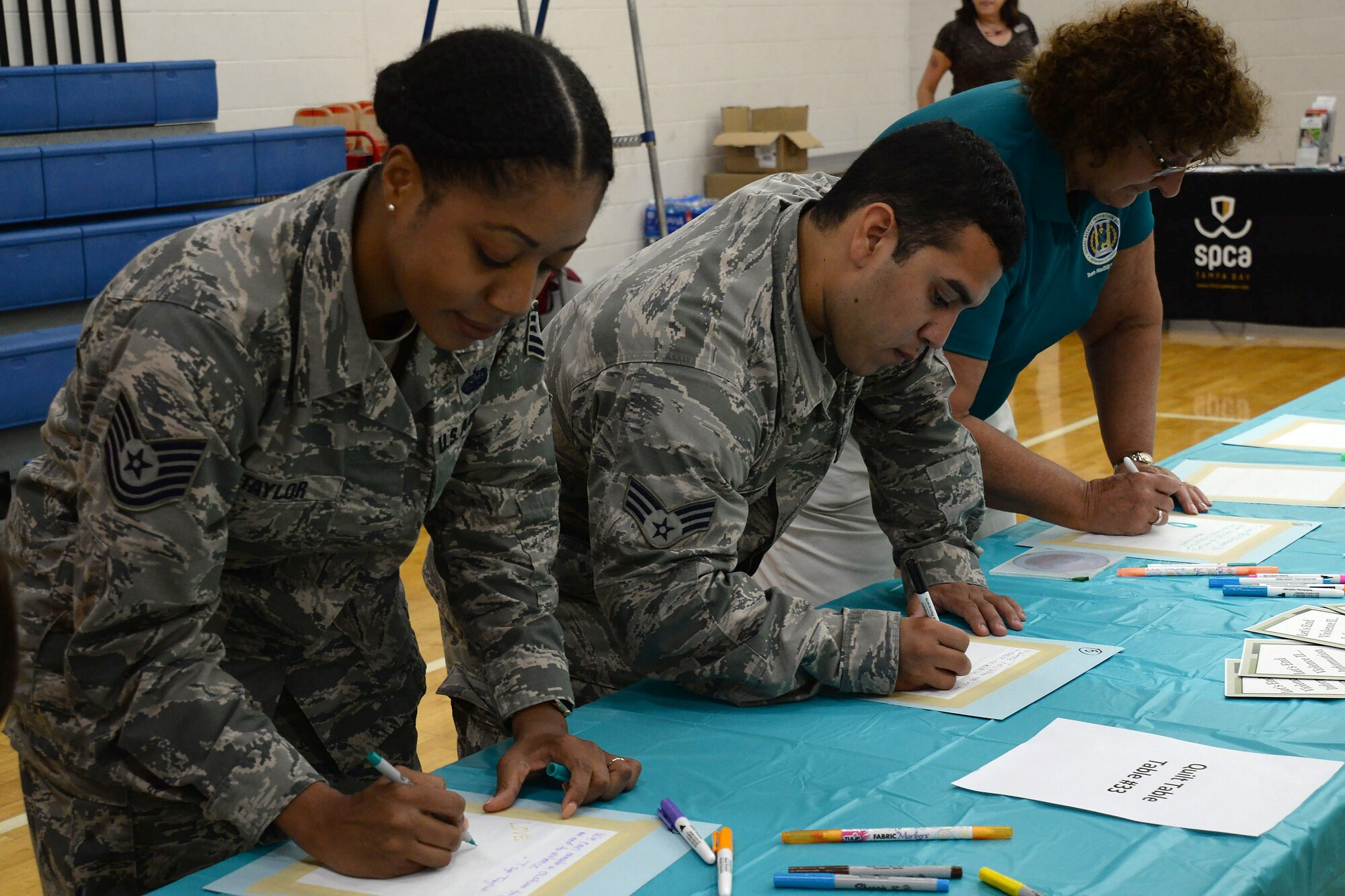 Airmen from the 6th Air Mobility Wing write a message of hope during the Sexual Assault Awareness and Prevention Month information expo at MacDill Air Force Base, Fla., April 4, 2017. The 2017 SAAPM theme is "Protecting Our People Protects Our Mission, Let's End Violence II.” (U.S. Air Force photo by Senior Airman Tori Schultz)