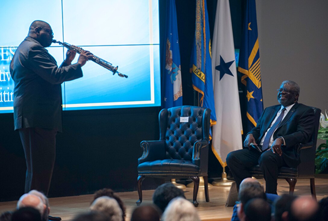 Wynueco Washington, a DLA Land and Maritime associate, surprised Lewis with a special performance of “Georgia on my Mind,” a tribute to Lewis’ hometown, during a March 31 retirement ceremony.
