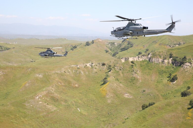 Two  AH-1Z Vipers with Marine Light Attack Helicopter Squadron (HMLA) 369 “Gunfighters” fly during a live-fire demonstration on Marine Corps Base Camp Pendleton, Calif., April 1. The unit conducted the demonstration as a part of HMLA-369’s 45th Anniversary celebration and family day. (U.S. Marine Corps photo by Lance Cpl. Jake M.T. McClung/Released)