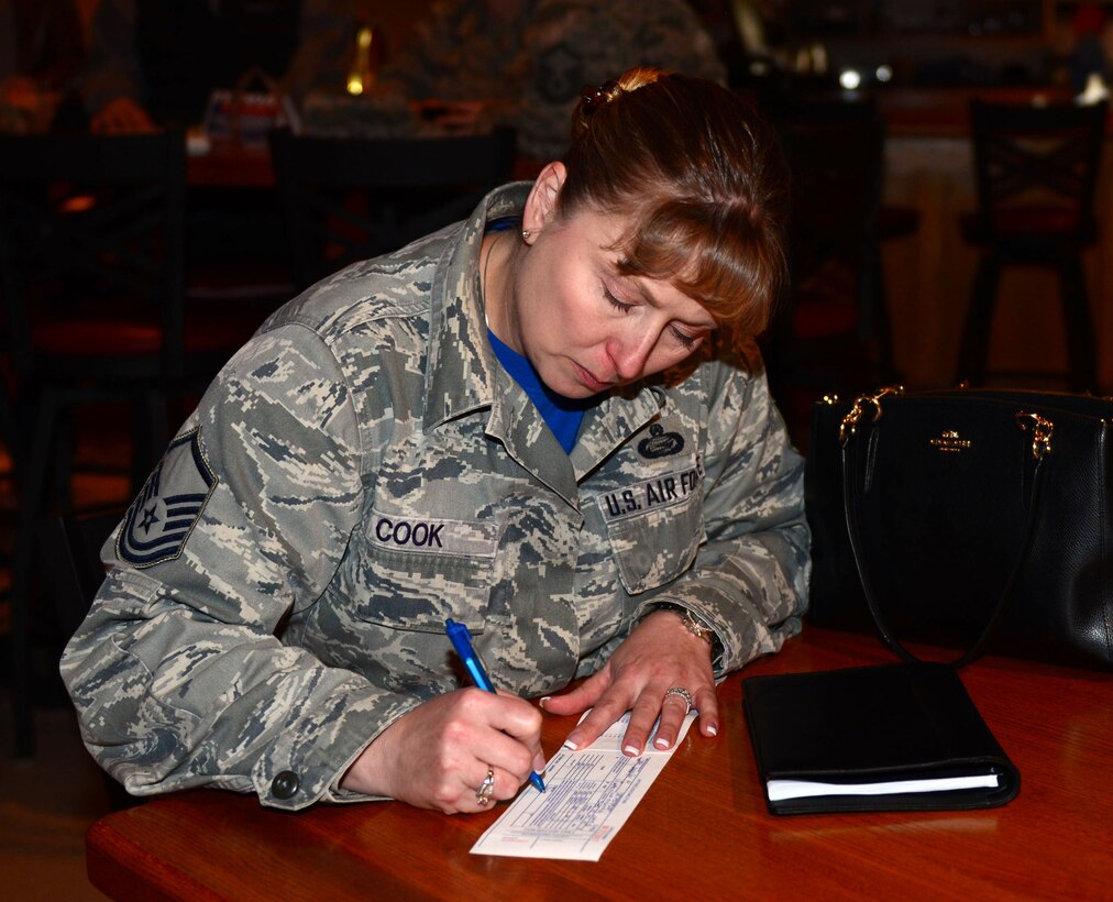 Master Sgt. Jennifer Cook, manpower office superintendent assigned to the 28th Force Support Squadron, donates to the Air Force Assistance Fund in the Dakota’s Cub at Ellsworth Air Force Base, S.D., March 31, 2017. The AFAF is an annual effort to raise funds for charitable affiliates that provide support to Air Force families in need including active duty, retirees, reservists, guard and dependents. (U.S. Air Force photo by Airman 1st Class Donald C. Knechtel)