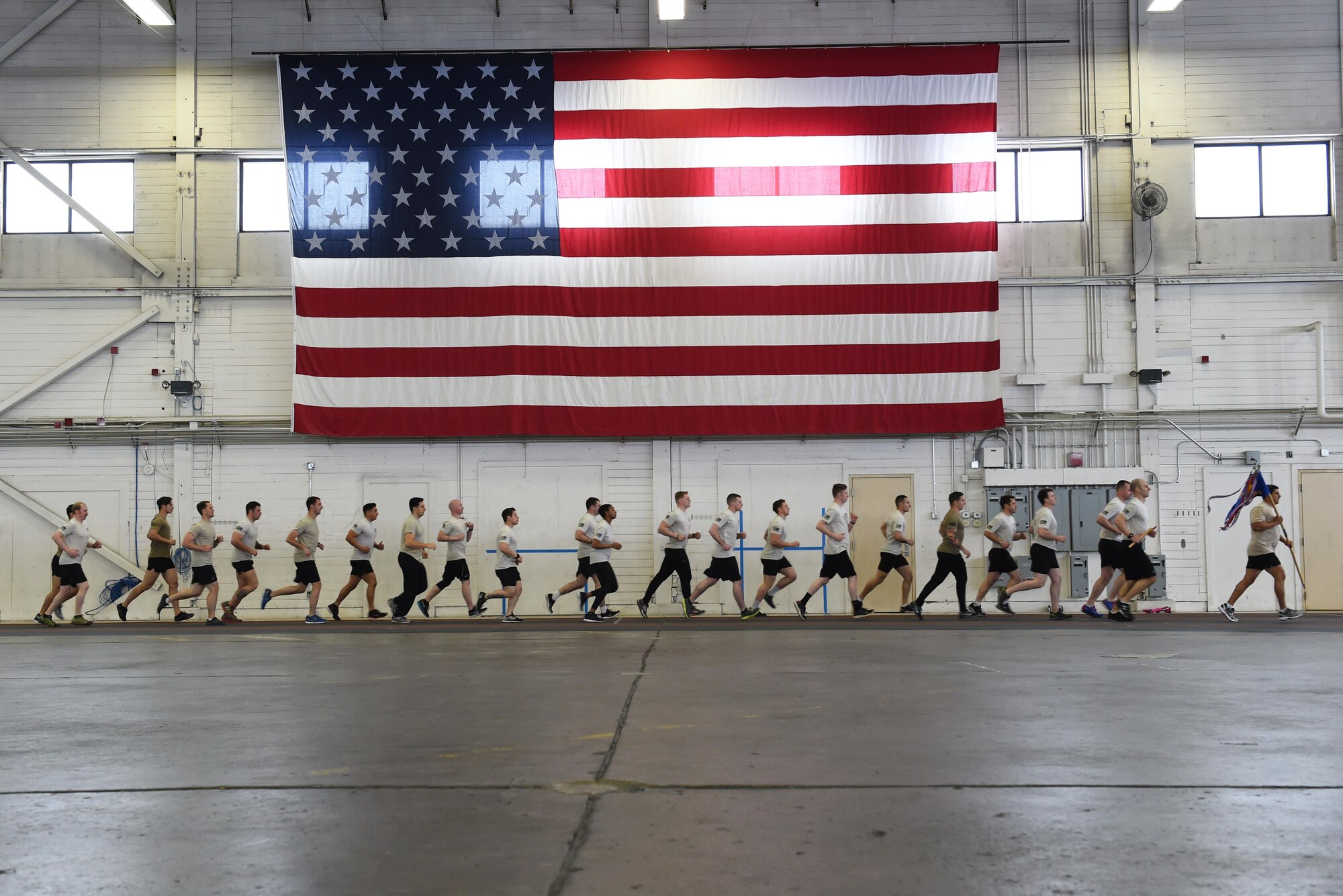 Members of the 3rd Air Support Operations Squadron complete a lap as a team in Hangar 5 at Joint Base Elmendorf-Richardson, Alaska, March 30, 2017, during the annual 24-hour run challenge. During the challenge, at least one tactical air control party member ran at any point during the 24 hours. The TACP Airmen also passed a baton listing the names of fallen TACP Airmen to ensure those who made the ultimate sacrifice are never forgotten. 