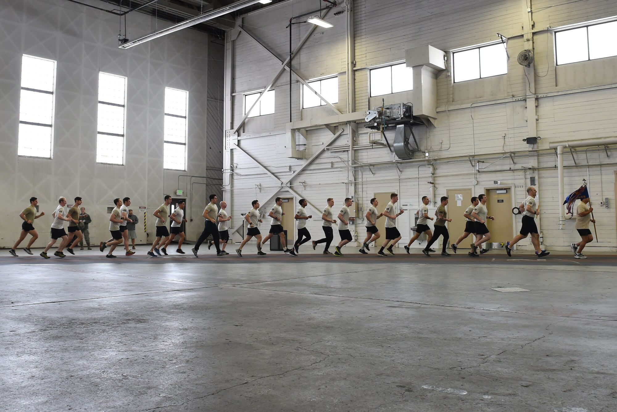 Members of the 3rd Air Support Operations Squadron complete a lap as a team in Hangar 5 at Joint Base Elmendorf-Richardson, Alaska, March 30, 2017, during the annual 24-hour run challenge. During the challenge, at least one tactical air control party member ran at any point during the 24 hours. The TACP Airmen also passed a baton listing the names of fallen TACP Airmen to ensure those who made the ultimate sacrifice are never forgotten. 