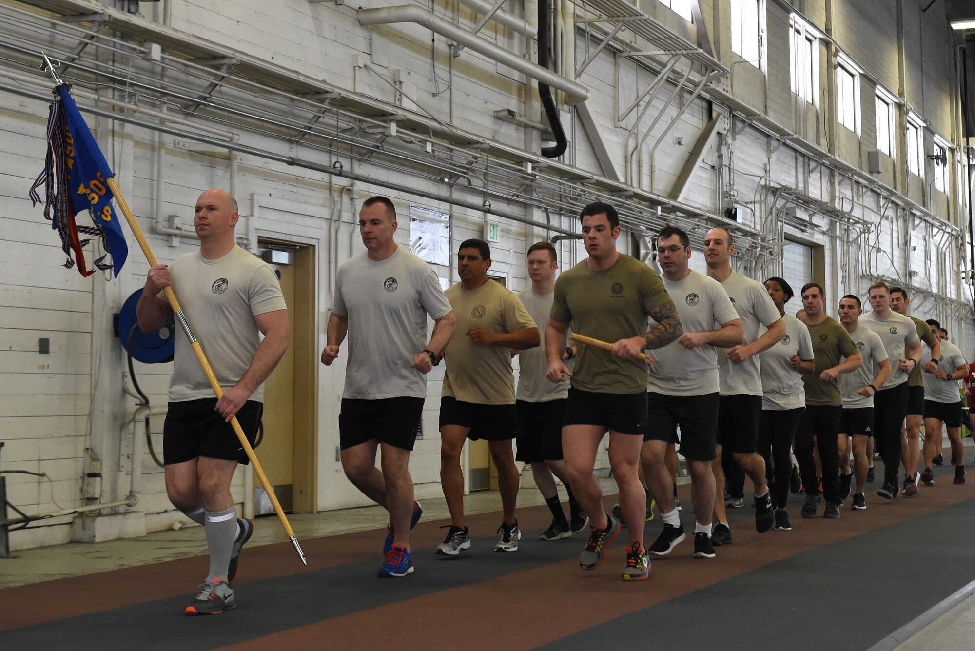 Members of the 3rd Air Support Operations Squadron complete a lap as a team in Hangar 5 at Joint Base Elmendorf-Richardson, Alaska, March 31, 2017, during the annual 24-hour run challenge. During the challenge, at least one tactical air control party member ran at any point during the 24 hours. The TACP Airmen also passed a baton listing the names of fallen TACP Airmen to ensure those who made the ultimate sacrifice are never forgotten. 