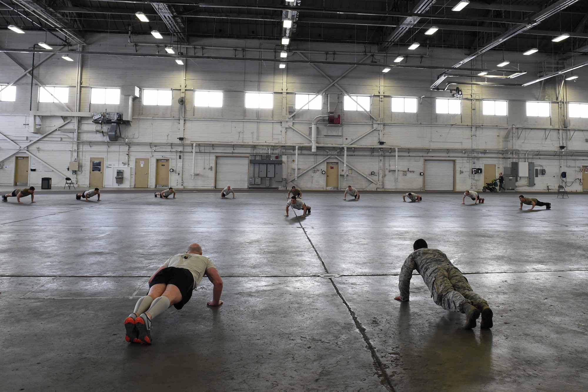 Members of the 3rd Air Support Operations Squadron do push-ups during a memorial ceremony after the annual 24-hour run challenge inside Hangar 5 at Joint Base Elmendorf-Richardson, Alaska, March 31, 2017. During the challenge, at least one tactical air control party member ran at any point during the 24 hours. The TACP Airmen also passed a baton listing the names of fallen TACP Airmen to ensure those who made the ultimate sacrifice are never forgotten. 