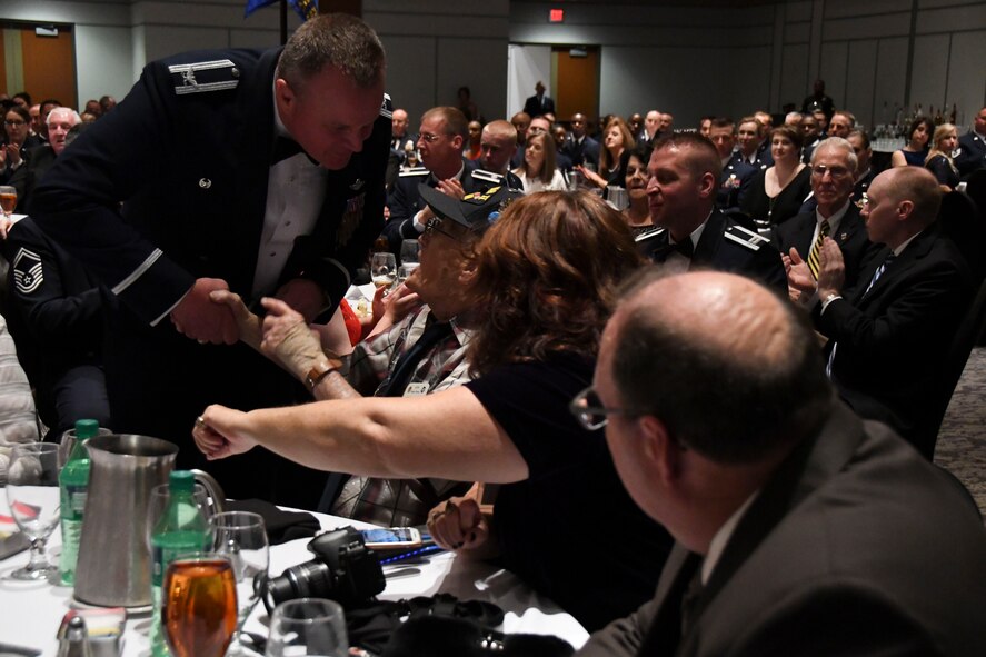 Col. Bruce R. Cox, 307th Bomb Wing commander, presents Dale Stickrath Jr., World War II 307th Bombardment Group veteran, with a Commander’s Coin during the 307th Bomb Wing’s 75th Anniversary and Awards Gala at the Shreveport Convention Center April 1, 2017. The reunion honored all alumni of the 307th Bombardment Group and current 307th Bomb Wing members and showcased the history of the wing since its inception during World War II. (U.S. Air Force photo by Staff Sgt. Callie Ware/Released)