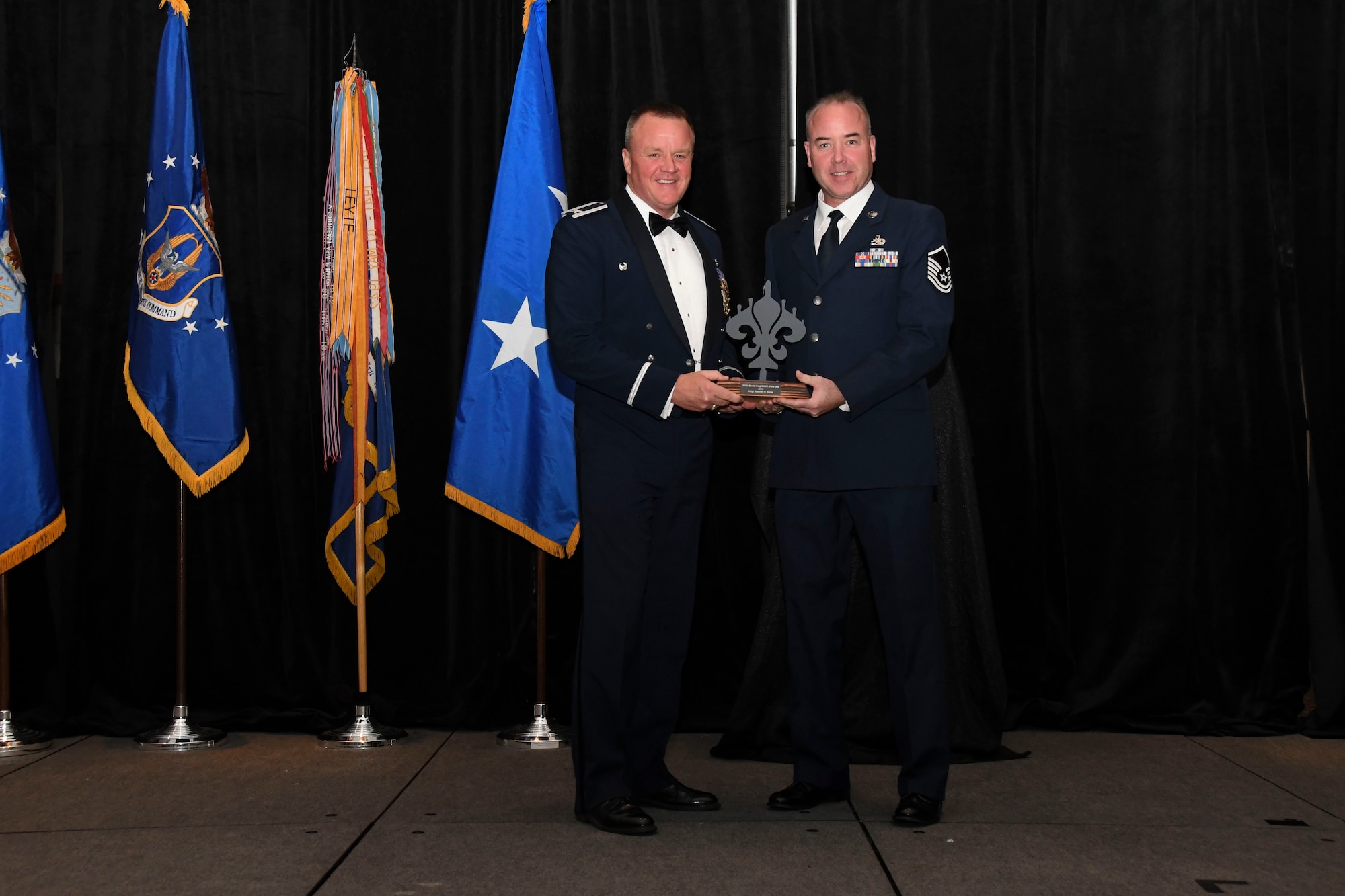 Col. Bruce R. Cox, 307th Bomb Wing commander, presents Master Sgt. Stephen Sorge, 307th Maintenance Squadron, the 307th Bomb Wing’s Senior Non-Commissioned Officer of the Year award for 2016. The award was presented during the 307th Bomb Wing’s 75th Anniversary and Awards Gala at the Shreveport Convention Center April 1, 2017. (U.S. Air Force photo by Staff Sgt. Callie Ware/Released)