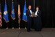 Col. Bruce R. Cox, the 307th Bomb Wing commander, presents Maj. Misty Bartley, 489th Bomb Group, the 307th Bomb Wing’s Field Grade Officer of the Year award for 2016. The award was presented during the 307th Bomb Wing’s 75th Anniversary and Awards Gala at the Shreveport Convention Center April 1, 2017. (U.S. Air Force photo by Staff Sgt. Callie Ware/Released)