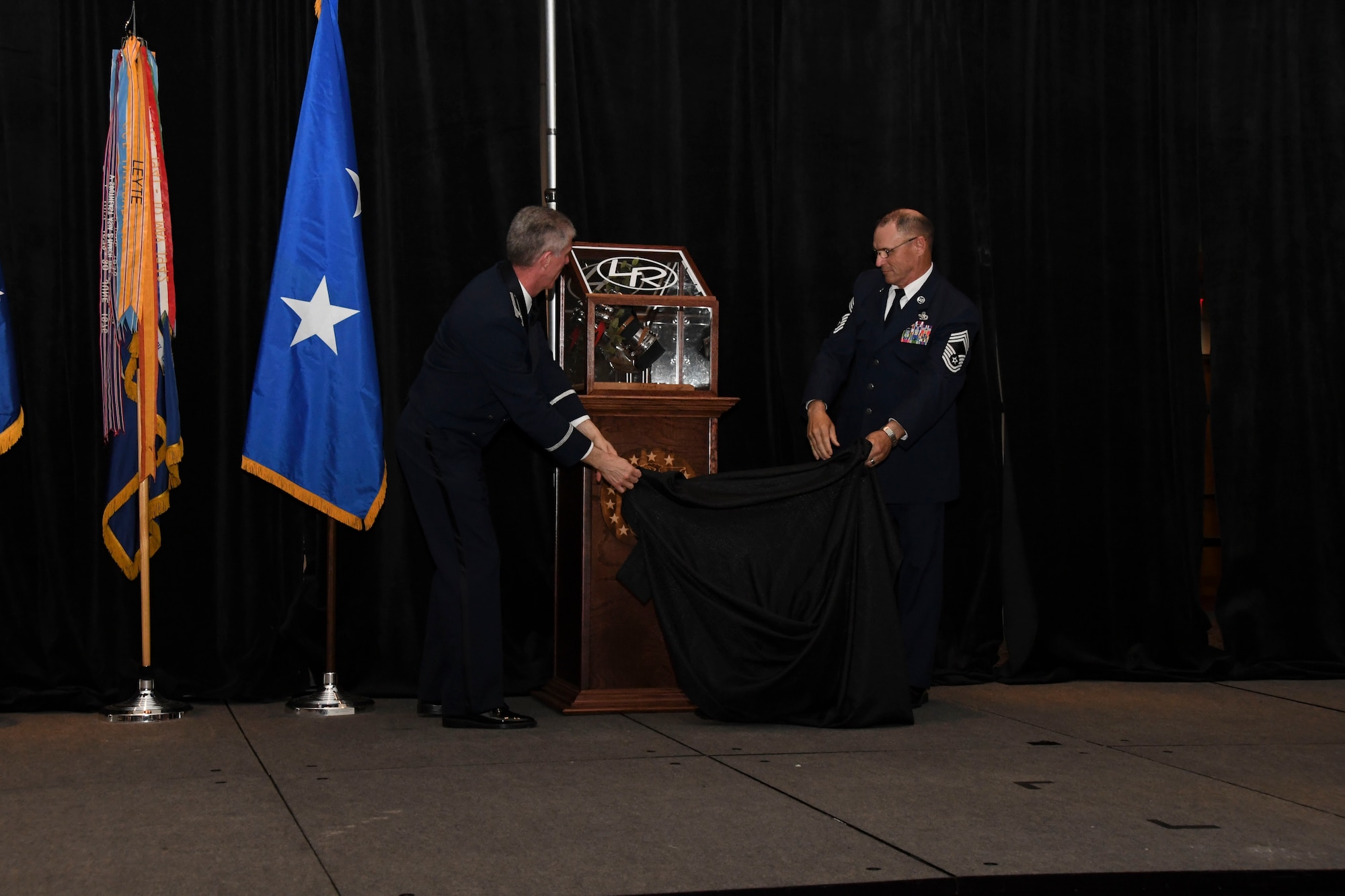 Col. James Morriss, 307th Bomb Wing vice commander, and Chief Master Sgt. Vernon Cox, 307th Maintenance Group, unveil the Zamperini Warrior Award during the 307th Bomb Wing’s 75th Anniversary and Awards Gala at the Shreveport Convention Center April 1, 2017. The Zamparini Warrior Award is awarded at the Wing Commander’s discretion to Airmen that reflect the characteristics of true warriors. (U.S. Air Force photo by Staff Sgt. Callie Ware/Released)