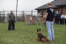 Staff Sgt. Alex Inn (left), Staff Sgt. Joshua Griffith (right) and canine Xxoe prepare to demonstrate various military working dog training scenarios for Junior Reserve Officer Training Corps members at Scott Air Force Base, Illinois, March 28, 2017. The students were shown how a MWD and their handler approach several scenarios including searching a suspect, guarding, and pursuing a suspect. Inn and Griffith are MWD handlers for the 375th Security Forces Squadron and Xxoe is one of the unit’s MWDs. (U.S. Air Force photo by Tech. Sgt. Jonathan Fowler)