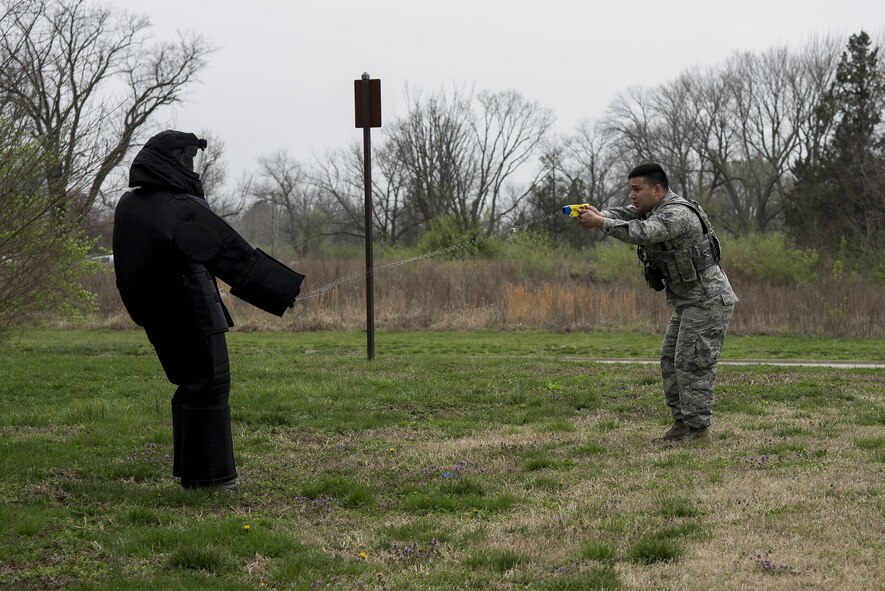 Senior Airman Leonardo Reyes Jr. (right), 375th Security Forces Squadron, fires a taser at Airman 1st Class Glenn Hodges, also 375th SFS, at Scott Air Force Base, Illinois, March 28, 2017. This was part of a demonstration held for Junior Reserve Officer Training Corps members and was designed to show them how SF members use tasers to subdue suspects. (U.S. Air Force photo by Tech. Sgt. Jonathan Fowler)