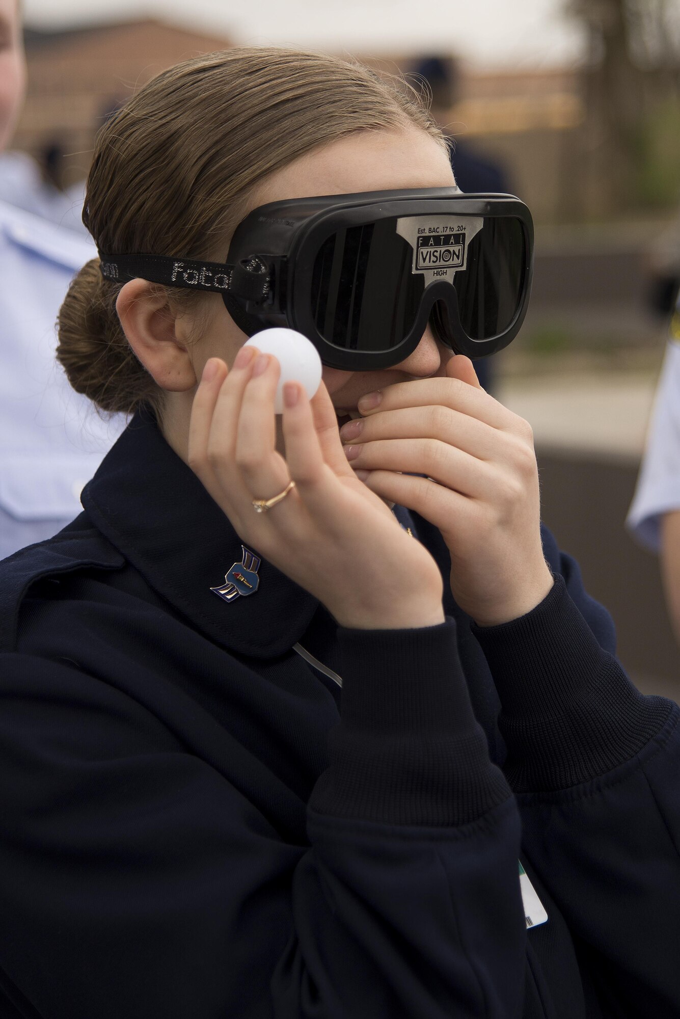 A Junior Reserve Officer Training Corps member laughs as she attempts to aim her throw while wearing ‘drunk goggles’ at Scott Air Force Base, Illinois, March 28, 2017. ‘Drunk Goggles’ are used to demonstrate various levels of alcohol impairment and are used by 375th Security Forces Members to showcase how being intoxicated can make simple actions more difficult and to emphasize the risks of driving while under the influence. (U.S. Air Force photo by Tech. Sgt. Jonathan Fowler)