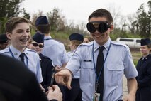 Two Junior Reserve Officer Training Corps members laugh as one attempts to touch the end of a pen while wearing ‘drunk goggles’ while visiting Scott Air Force Base, Illinois, March 28, 2017. ‘Drunk Goggles’ are used to demonstrate various levels of alcohol impairment and are used by 375th Security Forces Members to showcase how being intoxicated can make simple actions more difficult and to emphasize the risks of driving while under the influence. (U.S. Air Force photo by Tech. Sgt. Jonathan Fowler)