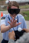 A Junior Reserve Officer Training Corps member drops a ball into a bag while wearing ‘drunk goggles’ during a visit to Scott Air Force Base, Illinois, March, 28, 2017. Junior ROTC members were also given a military working dog demonstration and shown how a taser is used and its effects. ‘Drunk Goggles’ are used to demonstrate various levels of alcohol impairment. (U.S. Air Force photo by Tech. Sgt. Jonathan Fowler)