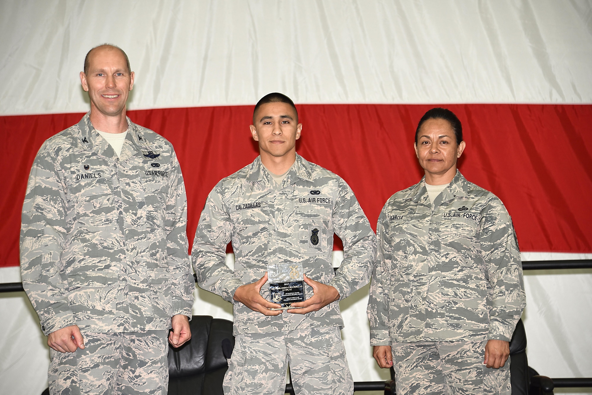 The Airman First Class Elizabeth N. Jacobson Award recipient, Staff Sgt. Orlando Calzadillas, 161st Security Forces Squadron, was recognized at the 161st Air Refueling Wing annual awards ceremony April 2, 2017, Goldwater Air National Guard Base. Col. Troy Daniels, 161st Air Refueling Wing commander and Chief Master Sgt. Martha Garcia, 161st Air Refueling Wing command chief presented. Calzadillas with the award. (U. S. Air National Guard photo by Staff Sgt. Wesley Parrell)
