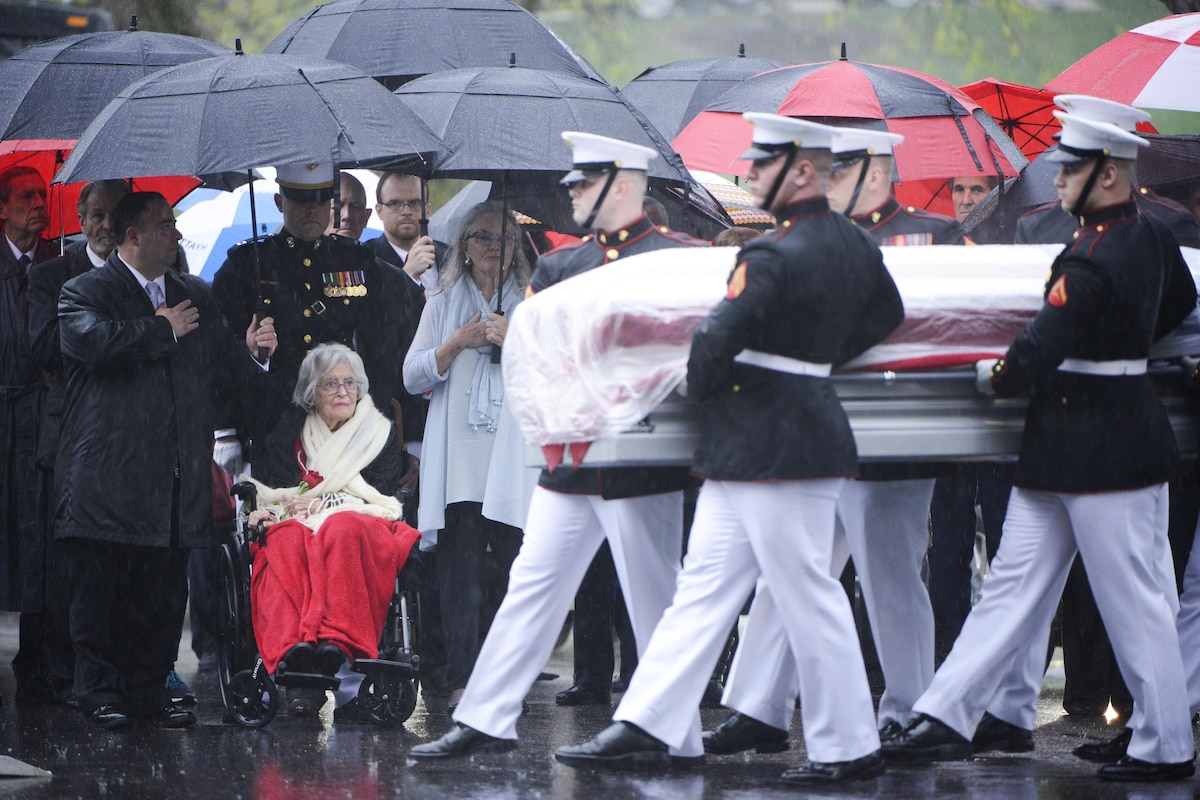 Marines carry the casket of Sen. John Glenn, a former astronaut, in the rain.