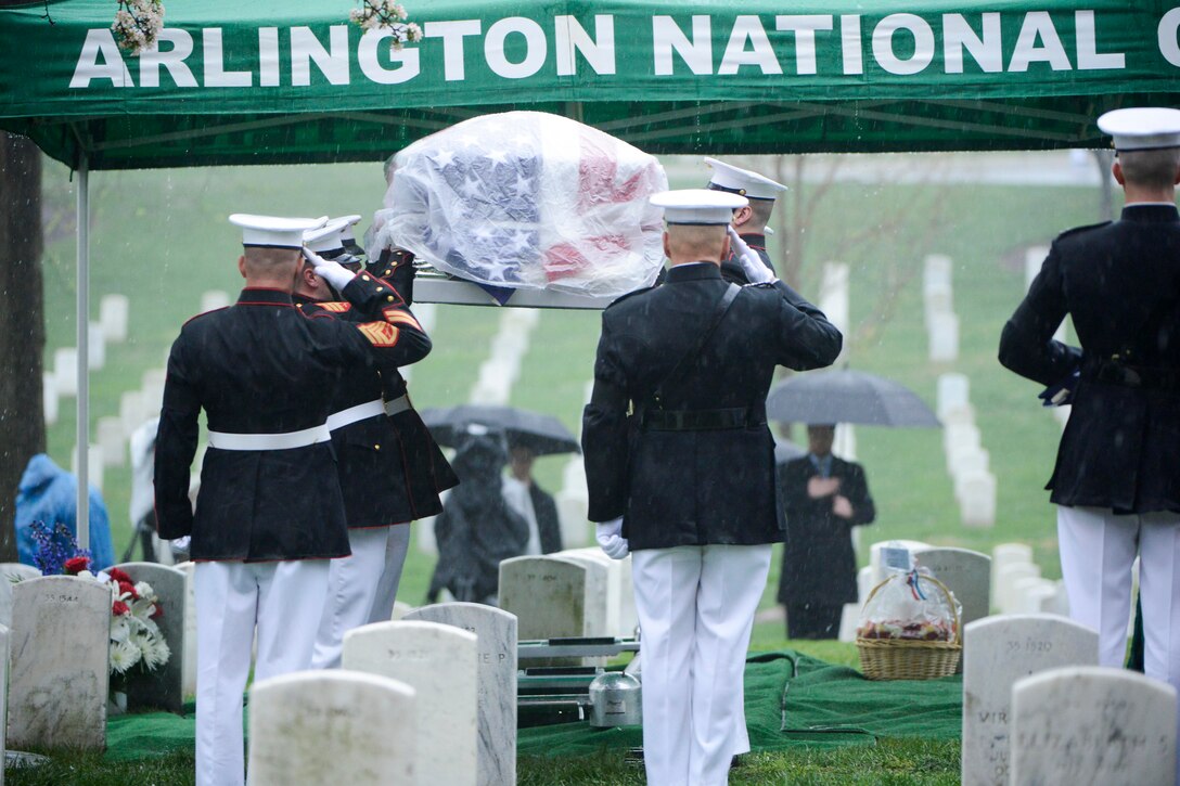 Marines assigned to Marine Barracks Washington carry John Glenn's casket from the caisson to the graveside during an interment ceremony in  Section 35 of Arlington National Cemetery in Arlington, Va., April 6, 2017. Glenn, a Marine who became the first American astronaut to orbit the Earth and later a U.S. senator, died Dec. 8, 2016. Army photo by Rachel Larue