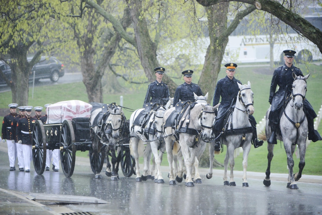 Marines assigned to Marine Barracks Washington, and members of the Army Caisson Platoon, part of the 3rd Infantry Regiment, escort the bodyJohn Glenn to his gravesite in Section 35 of Arlington National Cemetery in Arlington, Va., April 6, 2017. Glenn, a Marine who became the first American astronaut to orbit the Earth and later a United States senator, died at the age of 95 on Dec. 8, 2016. Army photo by Rachel Larue