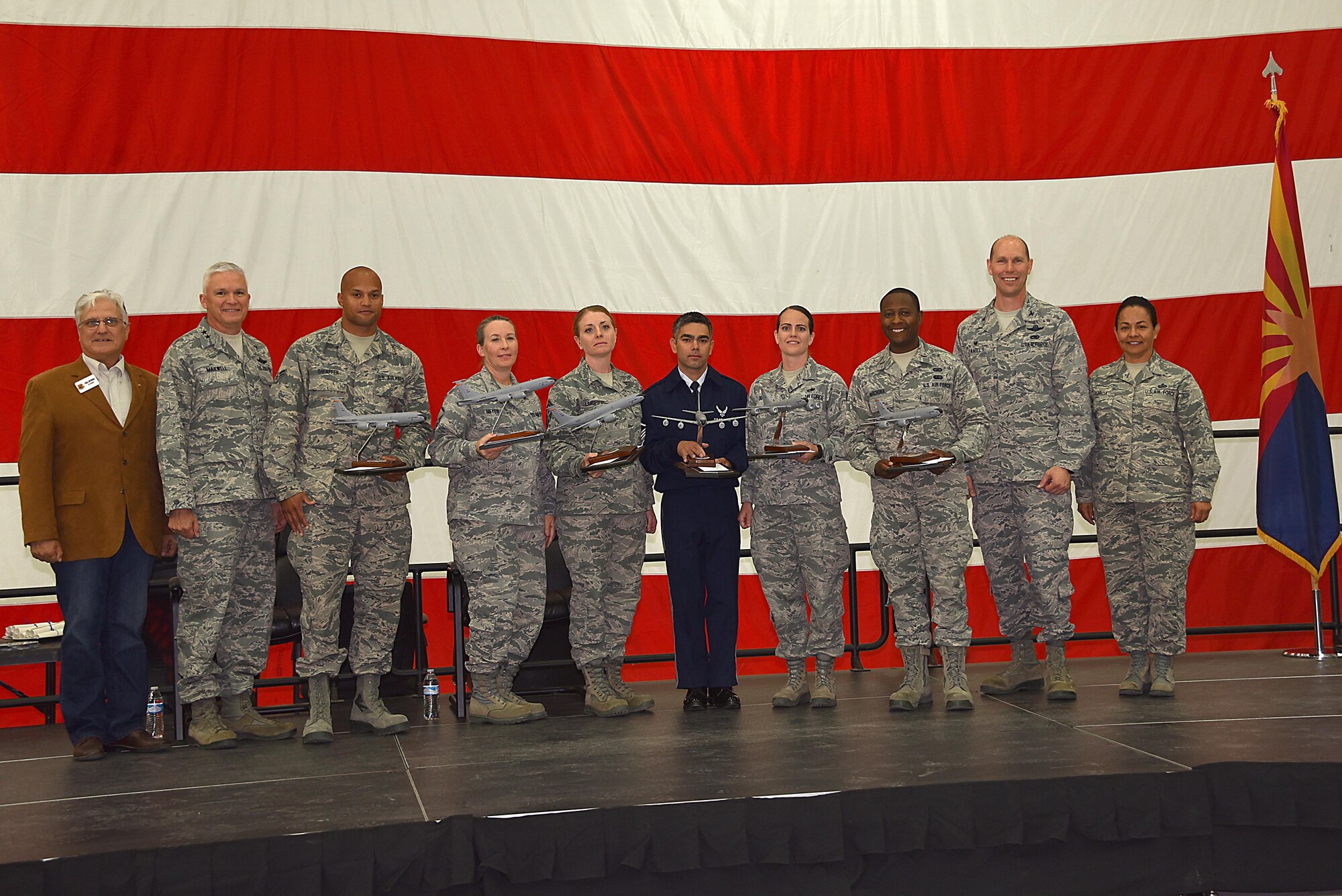 The Outstanding Airmen of the Year were recognized at the 161st Air Refueling Wing annual awards ceremony April 2, 2017, at Goldwater Air National Guard Base. From left to right: retired Chief Master Sgt. Glenn Klassen, Phoenix Air National Guard Patriots, Maj. Gen. Edward Maxwell, Arizona Air National Guard commander, Airman 1st Class Jonathan Sheaffer, Airman of the Year recipient, Master Sgt. Deanna Meyer, Senior Non-Commissioned Officer of the Year recipient, Senior Master Sgt. Rachel Landegent, First Sgt. of the year recipient, Master Sgt. Warren Edwards, Outstanding Honor Guard of the year recipient, Tech. Sgt. Aindrea Tait, Command Chief Master Sgt. Award recipient, 2nd Lt. Tinashe Machona, Maj. Gen. Donald L. Owens Junior Officer of the Year award recipient, Col. Troy Daniels, 161st Air Refueling Wing commander and Chief Master Sgt. Martha Garcia, 161st Air Refueling Wing command chief. (U. S. Air National Guard photo by Staff Sgt. Wesley Parrell)