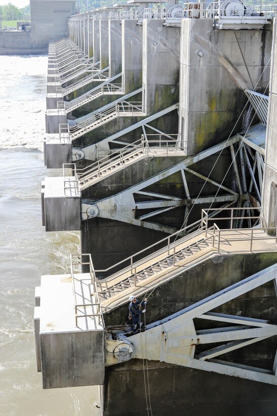 David Jarvis, an engineer with the U.S. Army Corps of Engineers - Tulsa District, inspects the gates on R.S. Kerr Lock and Dam (#15) as part of a periodic inspection.  Droesch is using the rope access technique, which allows him access to areas he would not have easily accessed by using the fall arrest method.  Rope access allows the inspectors to ascend and descend via ropes, while fall arrest requires them to scale the structure with only a safety line to keep them from falling. (photo by Thomas Mills USACE)