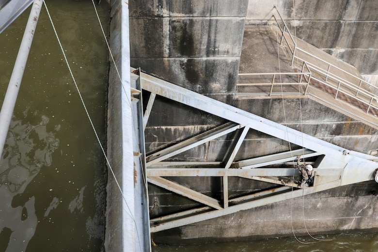 Major Doug Droesch, an engineer with the U.S. Army Corps of Engineers - Tulsa District, inspects the gates on R.S. Kerr Lock and Dam (#15) as part of a periodic inspection.  Droesch is using the rope access technique, which allows him access to areas he would not have easily accessed by using the fall arrest method.  Rope access allows the inspectors to ascend and descend via ropes, while fall arrest requires them to scale the structure with only a safety line to keep them from falling. (photo by Thomas Mills USACE)