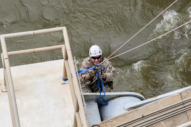 Major Doug Droesch, an engineer with the U.S. Army Corps of Engineers - Tulsa District, inspects the gates on R.S. Kerr Lock and Dam (#15) as part of a periodic inspection.  Droesch is using the rope access technique, which allows him access to areas he would not have easily accessed by using the fall arrest method.  Rope access allows the inspectors to ascend and descend via ropes, while fall arrest requires them to scale the structure with only a safety line to keep them from falling. (photo by Thomas Mills USACE)