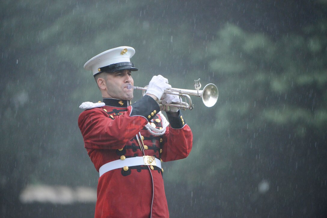 Marine Sgt. Christian Rangeo, bugler with the Marine Drum and Bugle Corps, plays taps during the graveside service for John Glenn in Section 35 of Arlington National Cemetery in Arlington, Va, April 6, 2017. Glenn, a Marine who became the first American astronaut to orbit the Earth and later a United States senator, died at the age of 95 on Dec. 8, 2016. Army photo by Rachel Larue