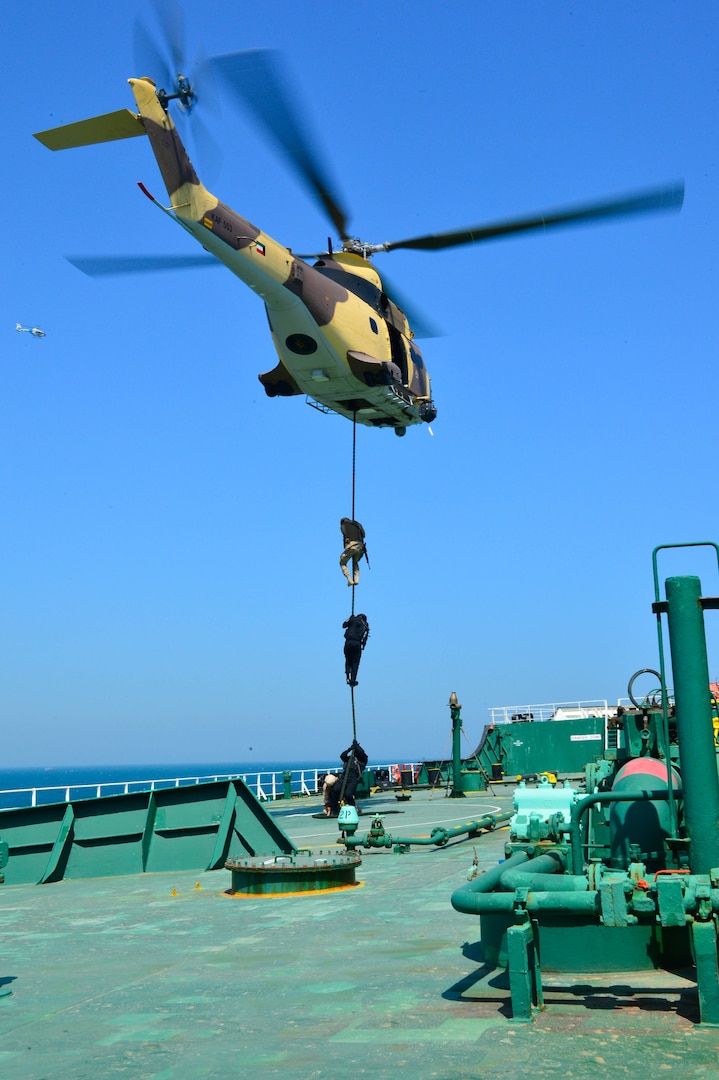 KUWAIT - Gulf Cooperation Council special operations forces execute a fast rope exercise aboard the Kuwait oil tanker the Hadiya, April 3, in Kuwait territorial waters as part of a simulated recovery mission during exercise Eagle Resolve 2017. (U.S. Army Photo by Master Sgt. Timothy Lawn)