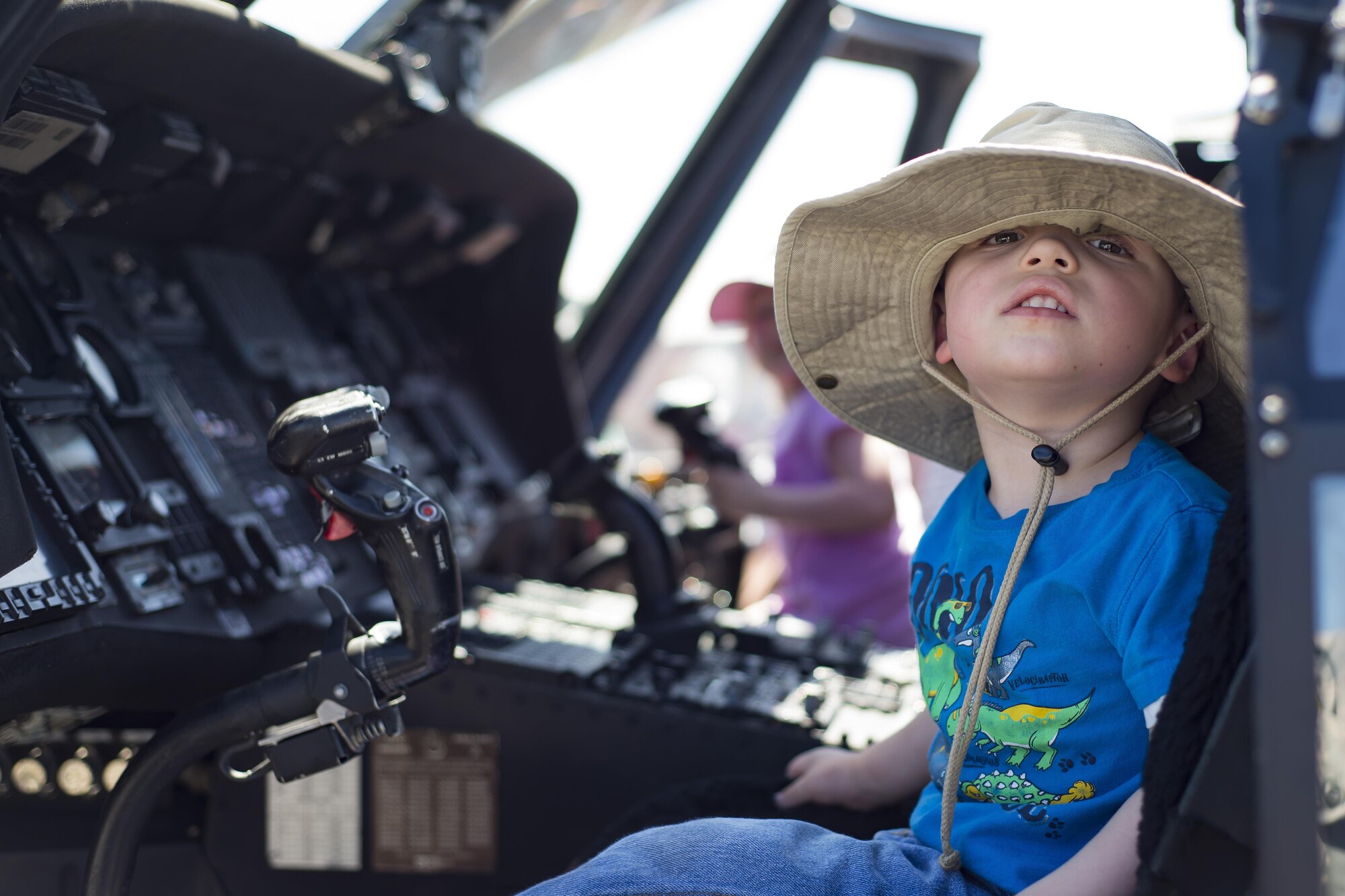 A young spectator smiles in the pilot seat of an HH-60G Pave Hawk during the Melbourne Air & Space Show April 1, 2017, in Melbourne, Fla. Airmen from the 920th Rescue Wing displayed the helicopter and equipment used to accomplish the combat search-and-rescue mission. The airshow attracted nearly 200,000 participants and showcased both military and civilian aircraft. (U.S. Air Force photo/Staff Sgt. Jared Trimarchi)