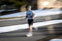 A Soldier sprints toward the finish line during the two-mile run portion of the Army Physical Fitness Test during the 80th Training Command and 99th Regional Support Command's combined Best Warrior Competition at Fort Devens, Massachusetts April, 3, 2017.