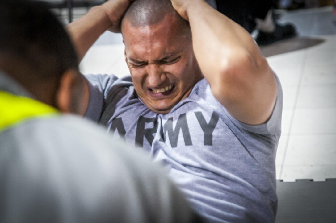 Sergeant Wilbert Peralta, a competitor from the 1st Brigade, 8-80th, 94th Division, fights to sit up as time ticks down during the 80th Training Command and 99th Regional Support Command's combined Best Warrior Competition at Fort Devens, Massachusetts April, 3, 2017.