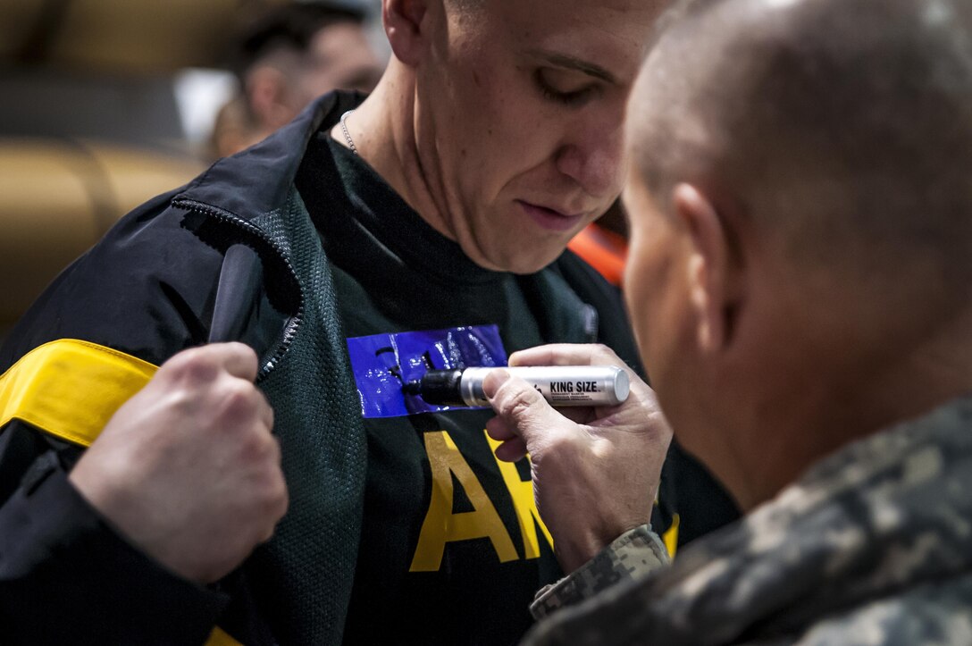 A soldier gets marked with a number prior to the start of the two-mile run portion of the Army Physical Fitness Test during the 80th Training Command and 99th Regional Support Command's combined Best Warrior Competition at Fort Devens, Massachusetts April, 3, 2017.