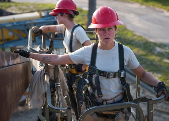 Staff Sgt. Keny Drescher-Brown, an 823rd Red Horse Squadron structures Airman, coordinates with Airmen in another lift March 23, 2017, during a construction project at Eglin Air Force Base, Fla. The 96th Civil Engineer Group’s open air pavilion is one of many troop training projects the 823rd RHS will complete for the Defense Department, the Air Force and the local community to maintain their skills until the next deployment. (U.S. Air Force photo/Ilka Cole)