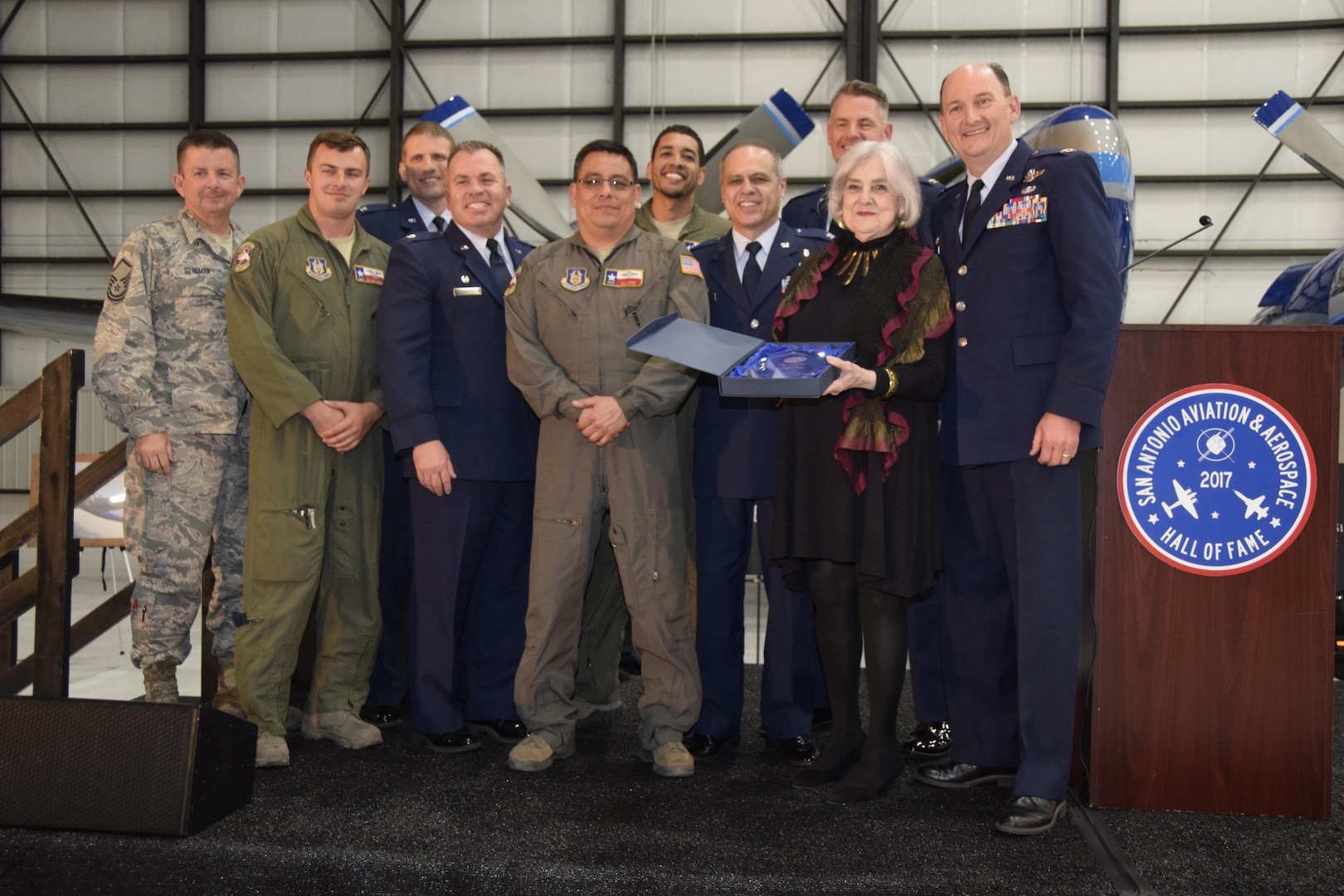 Members from the 433rd Airlift Wing, Joint Base San Antonio-Lackland, Texas join Col. Thomas K. "TK" Smith, Jr, 433rd AW commander, accepted induction into the San Antonio Aviation and Aerospace Hall of Fame, during an awards dinner, March 30, 2017 at the GDC Technics Hangar, Port San Antonio, (formerly Kelly Air Force Base), Texas. (U.S. Air Force photo by Minnie Jones)