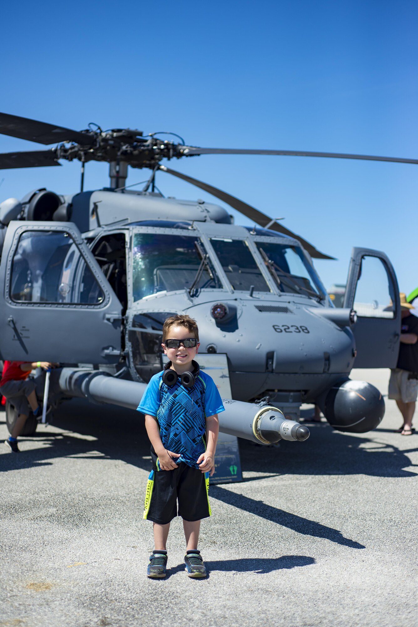 A young boy stands in front of an HH-60G Pave Hawk during the Melbourne Air & Space Show April 1, 2017, at Melbourne, Fla. Airmen from the 920th Rescue Wing displayed the helicopter and equipment used to accomplish the combat search-and-rescue mission. The airshow attracted nearly 200,000 participants and showcased both military and civilian aircraft. (U.S. Air Force photo/Staff Sgt. Jared Trimarchi)