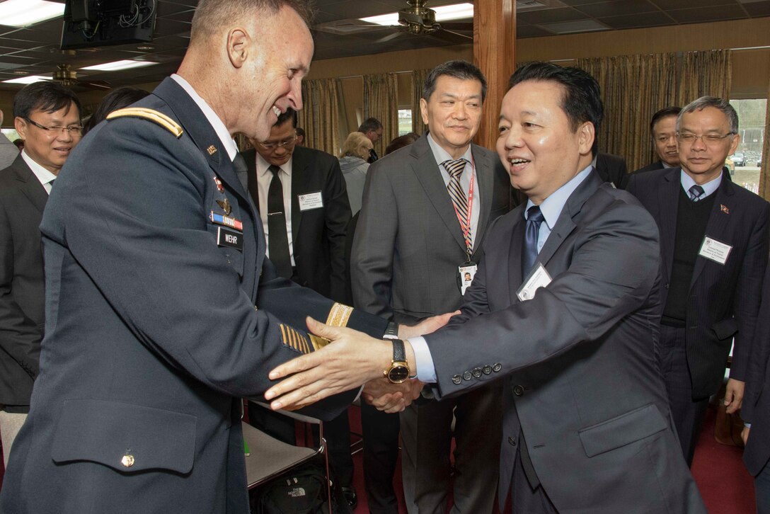 Lt. Gen. Michael C. Wehr (left), President of the Mississippi River Commission, greets Dr. Tran Hong Ha (right), Vietnam’s Minister of Natural Resource and Environment, aboard the Corps of Engineers’ Motor Vessel Mississippi.